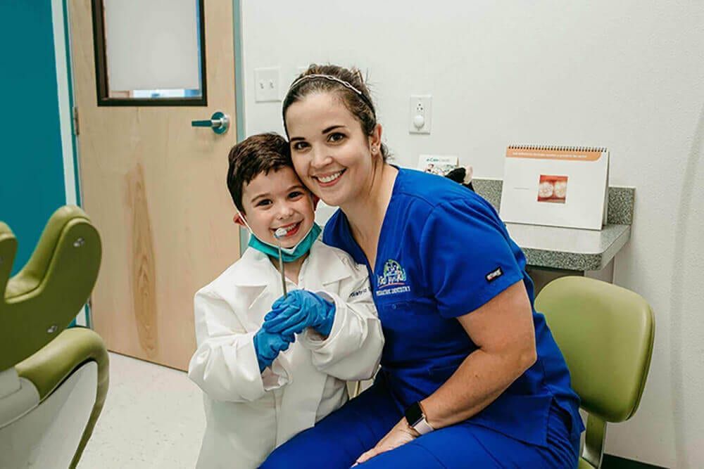 a young patient with dentist smiling