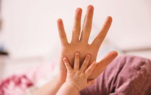 Infant Hand Holding Adult Hand
