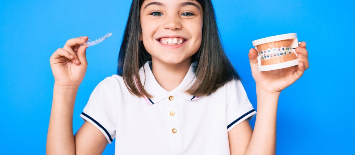 Young,Little,Girl,With,Bang,Holding,Invisible,Aligner,Orthodontic,And